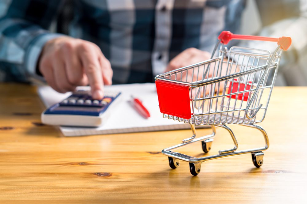 Senior calculating shopping budget.