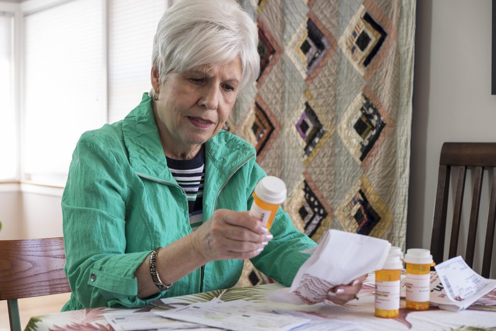 Woman looking at prescription medicine. 