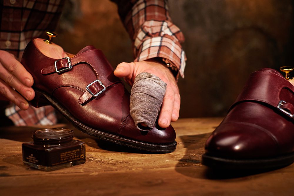 Man shining his shoes.