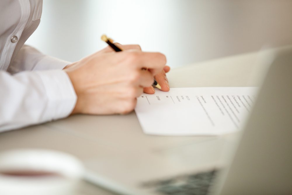 Signing a document.