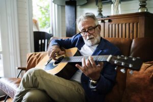 Senior with guitar.