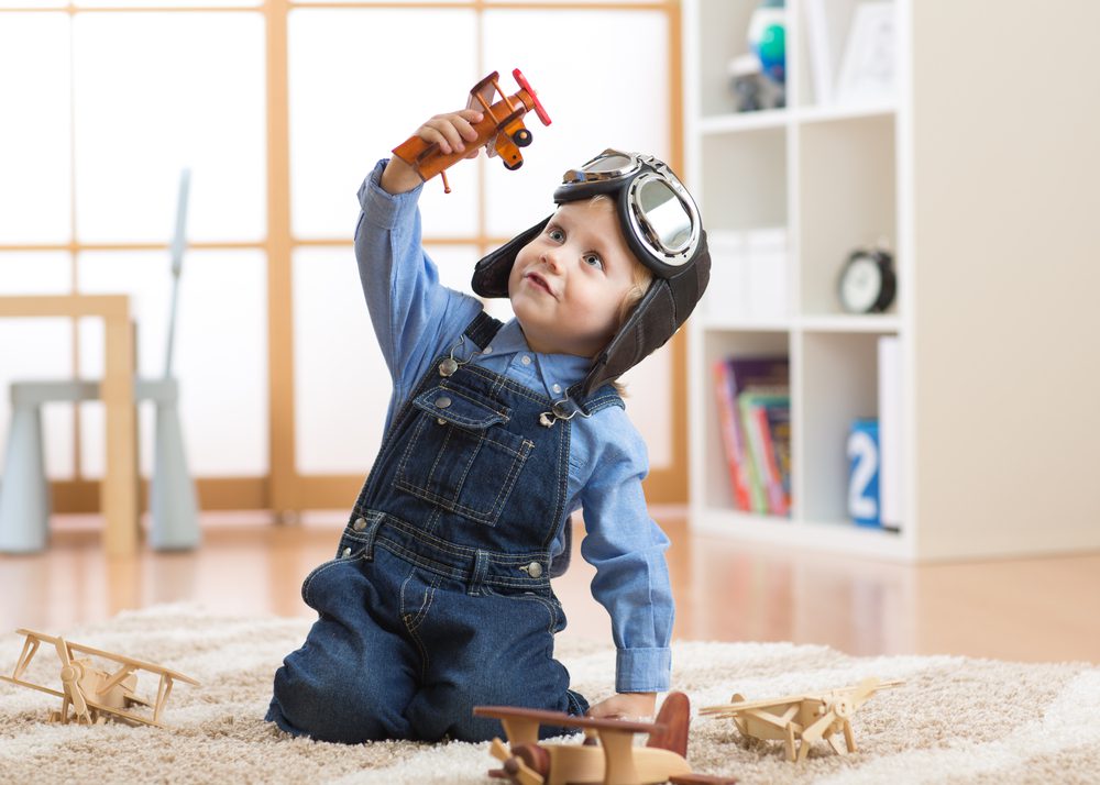 Little boy playing with toys. 