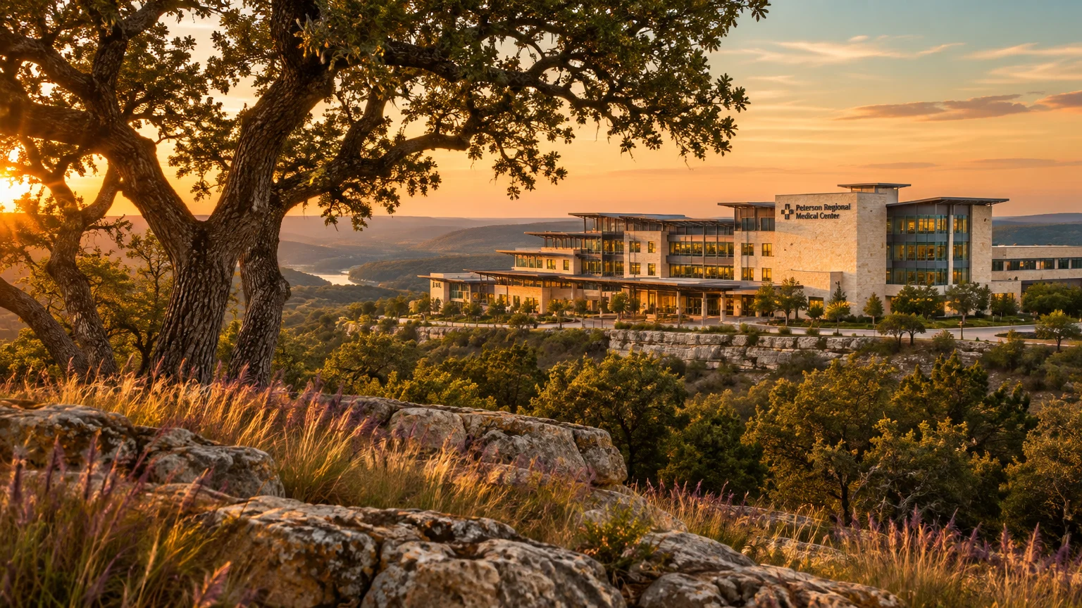 Peterson Regional Medical Center building situated on a hillside overlooking rolling hills at sunset.