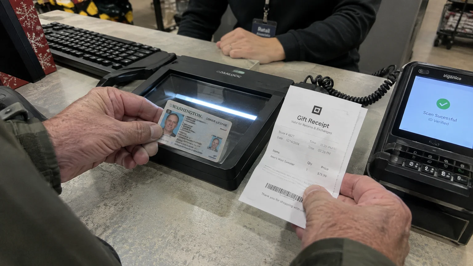 A customer holds a driver's license over a scanner counter next to a gift receipt and a payment terminal showing ID Verified.